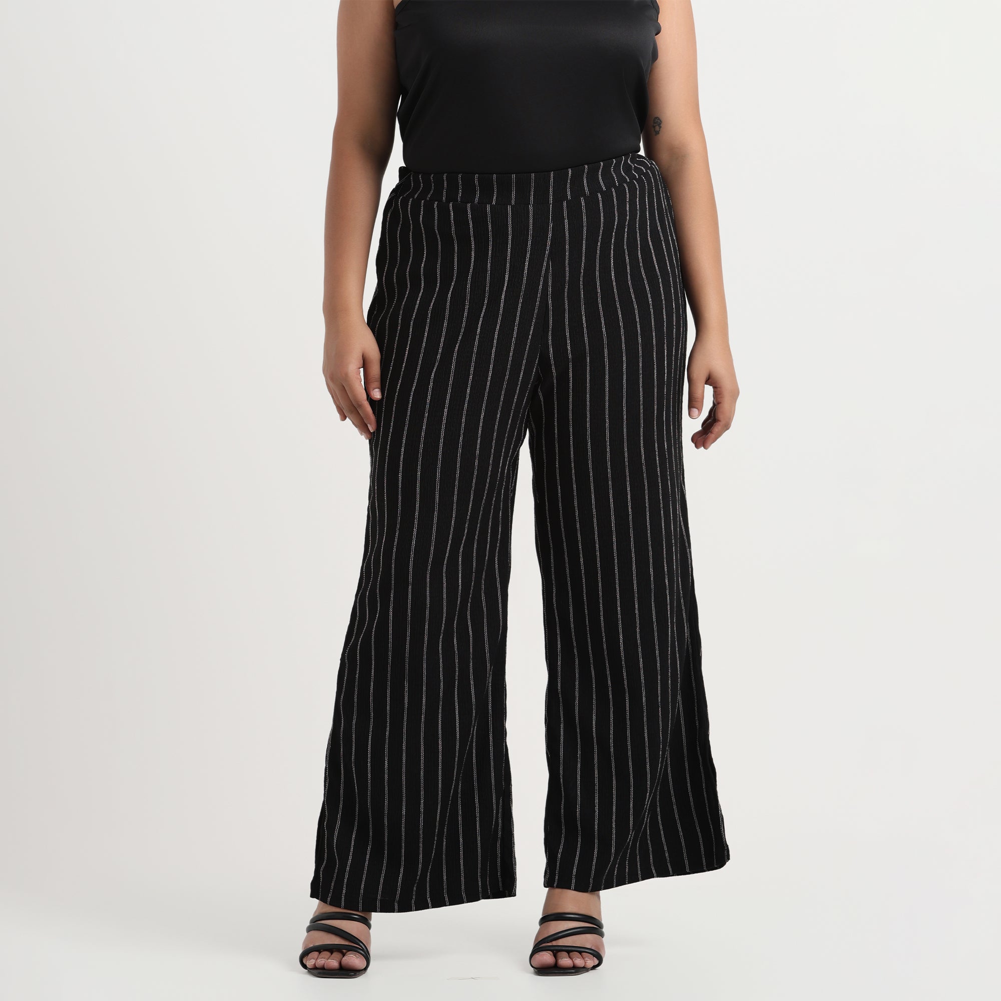 Black textured striped pants with a slim fit and elegant detailing, side view
