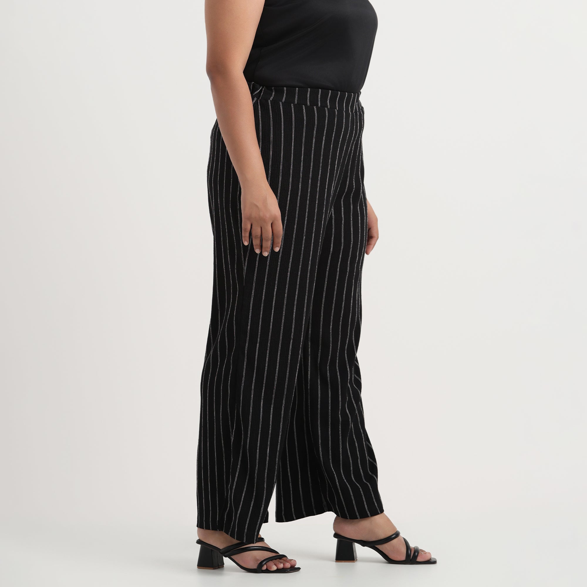 Black textured striped pants showcasing vertical stripe design, front view
