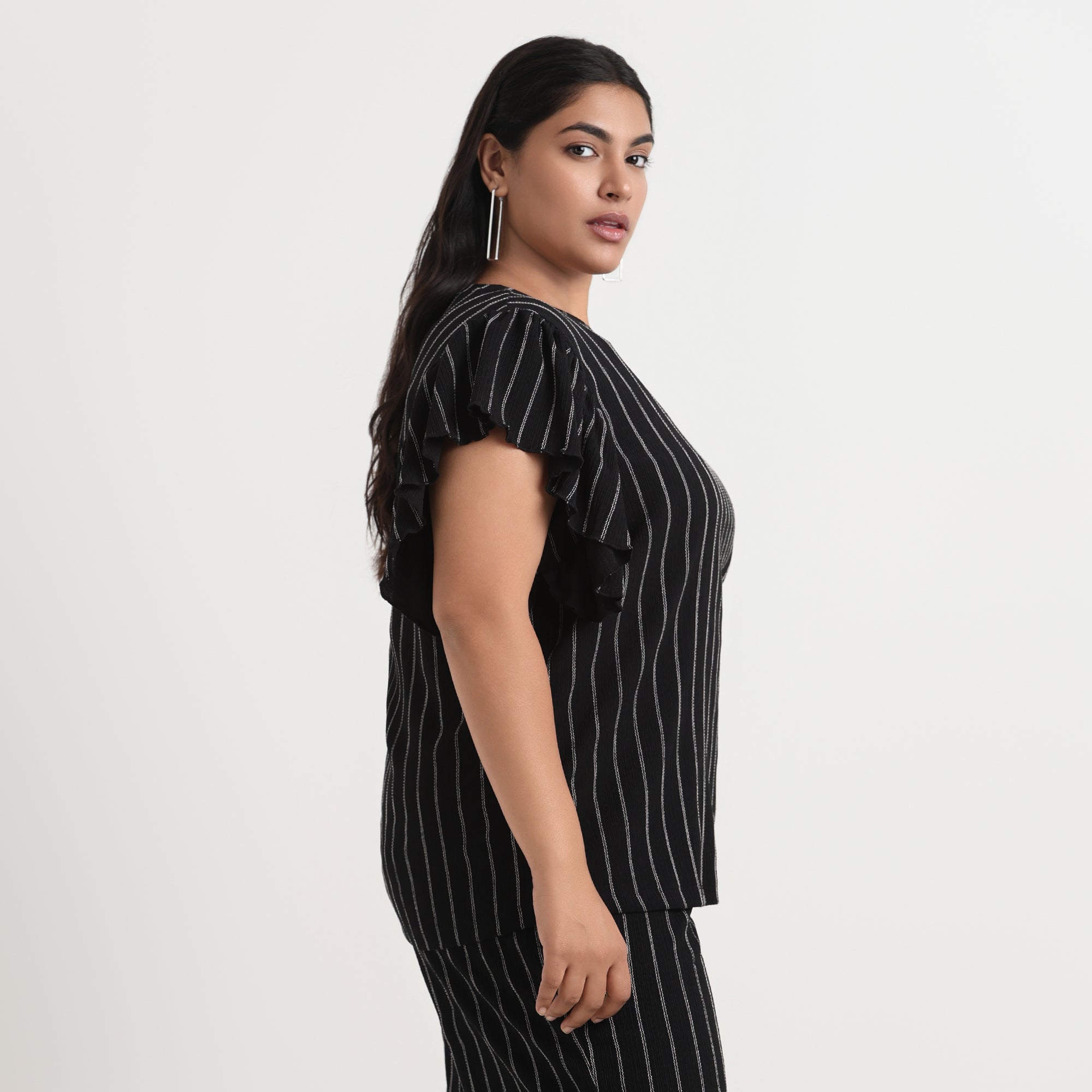 Black textured striped top with a relaxed fit, perfect for casual or semi-formal wear.
