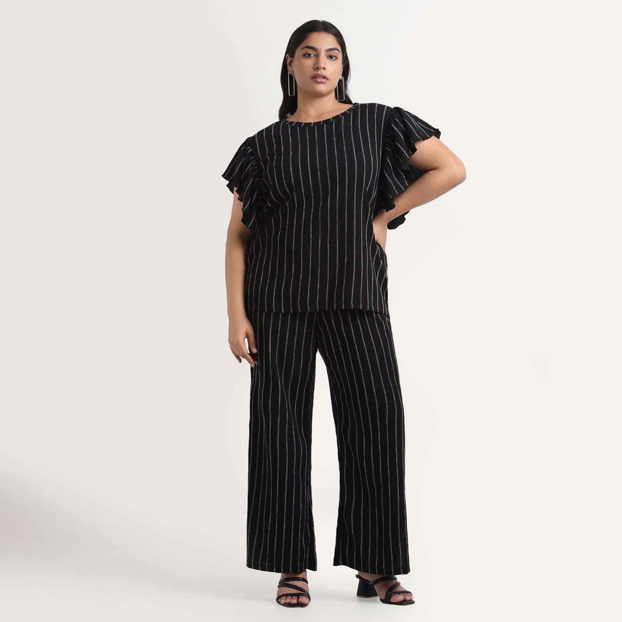 Black textured striped top with a modern look, tailored for plus sizes.
