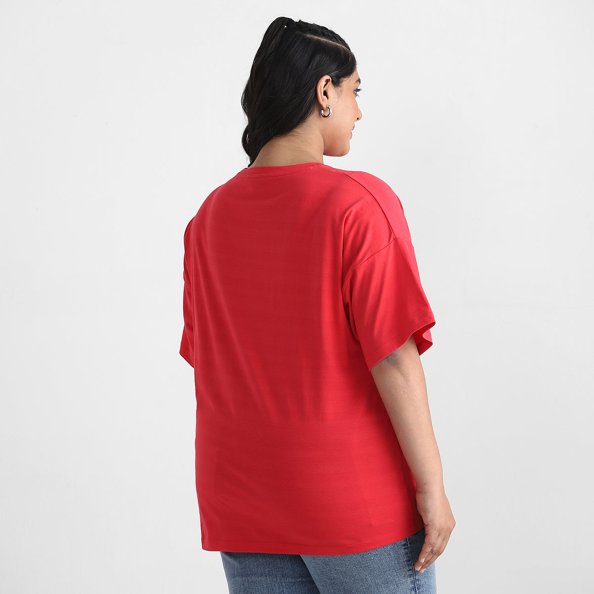 Image showcasing backside of women in red t-shirt