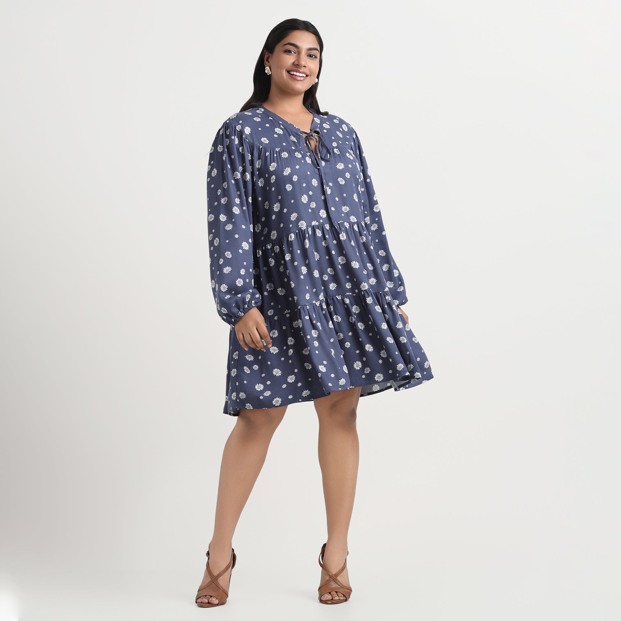 Blue dress with a daisy print, featuring a flattering A-line cut for plus sizes.
