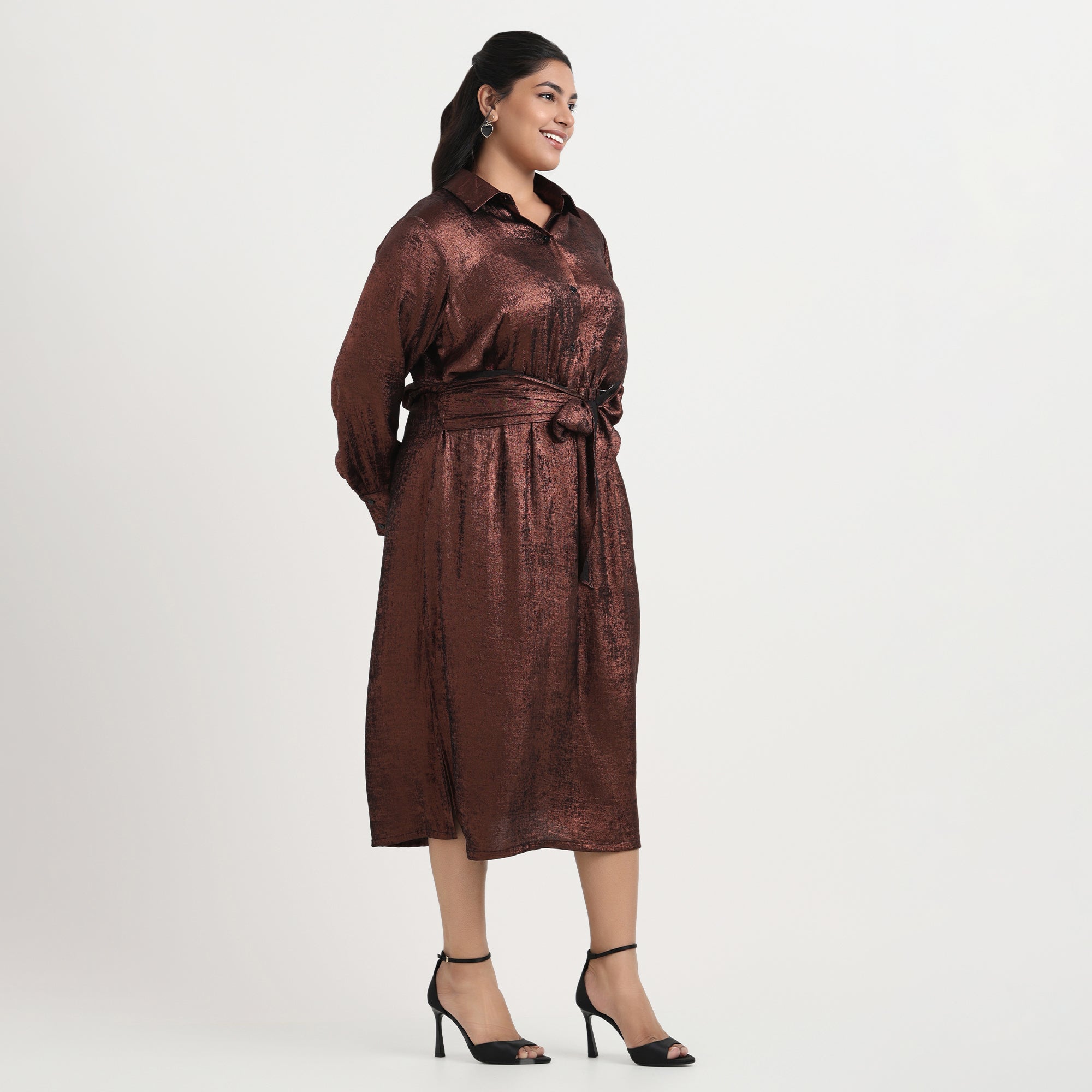 Gold foil shirt dress with a lustrous shine, long sleeves, and a relaxed silhouette.
