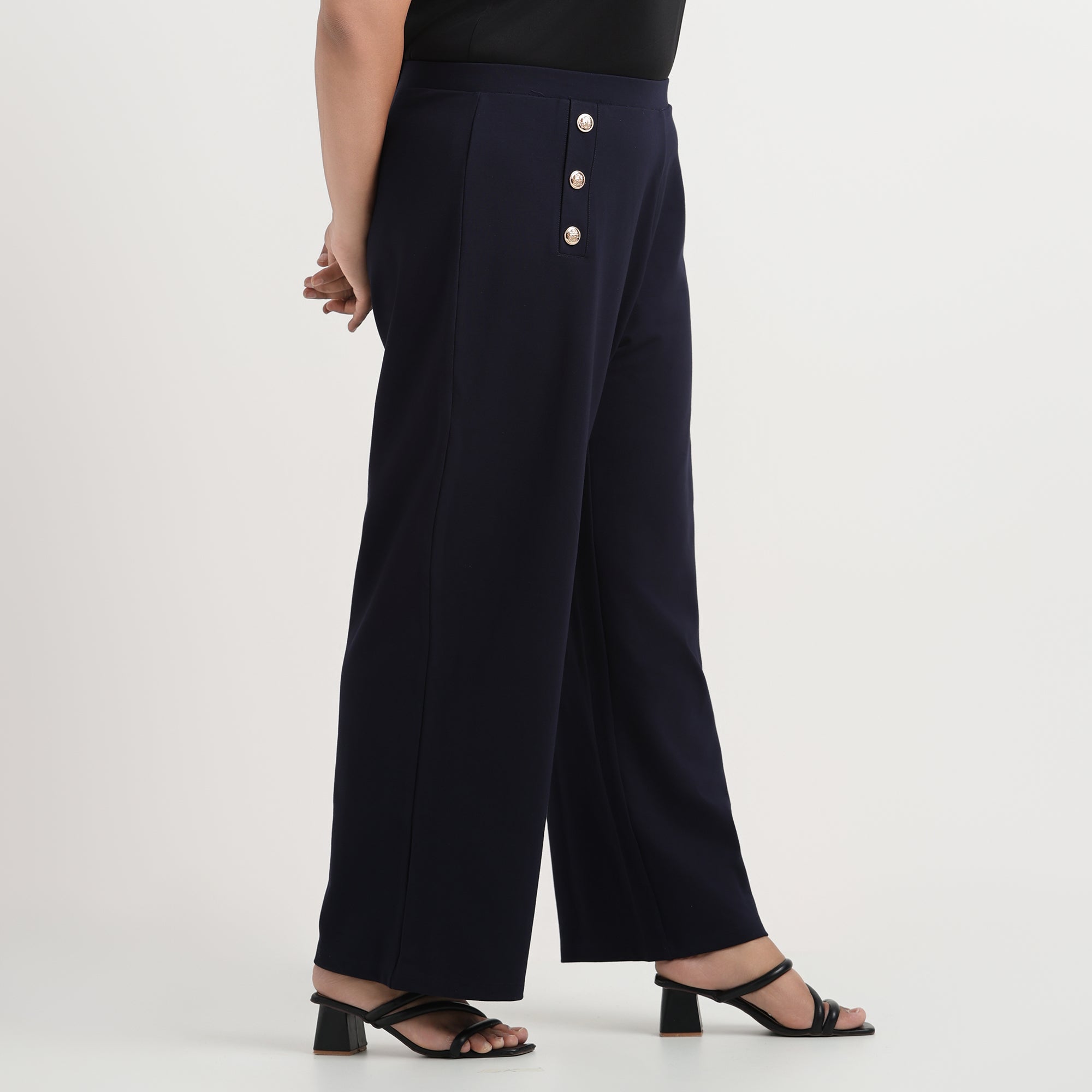 Navy blue buttoned flared pants with a high-waist design and a chic, relaxed fit.
