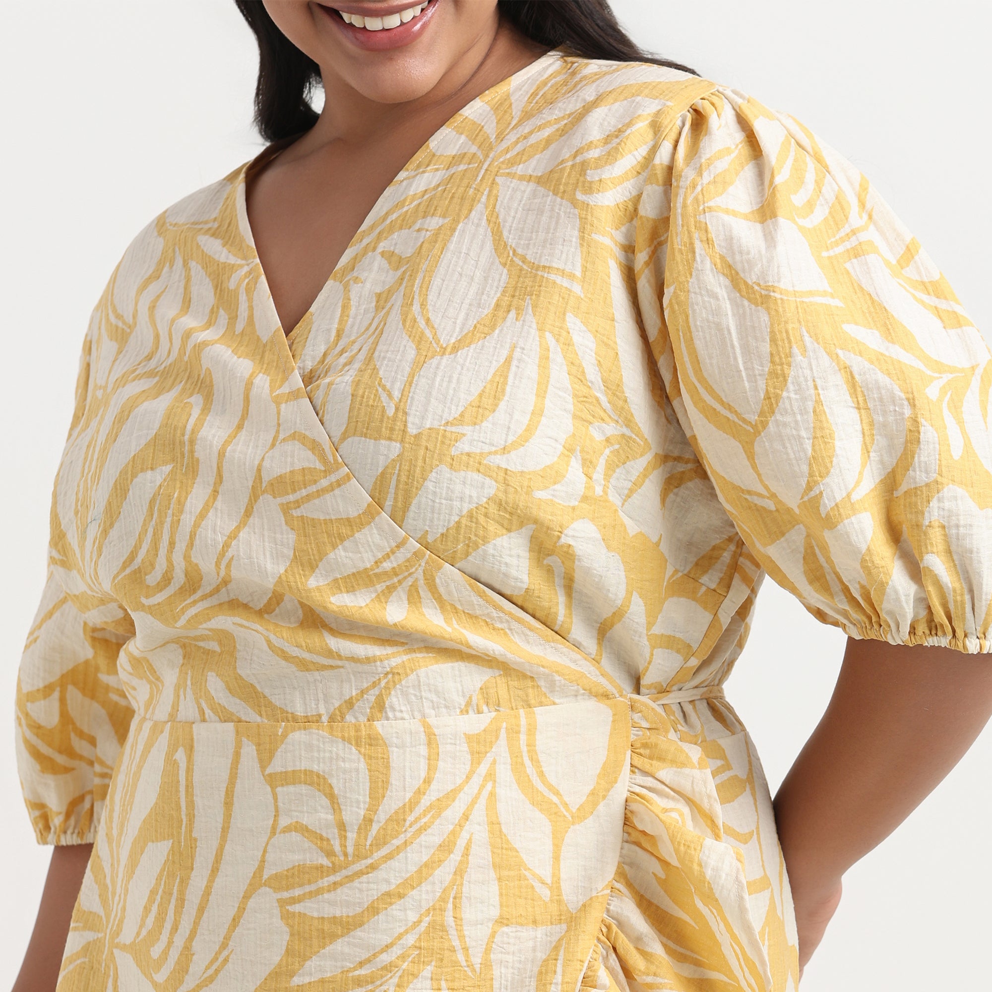 Yellow dress with a vibrant print, designed with a flattering, A-line cut for plus sizes.
