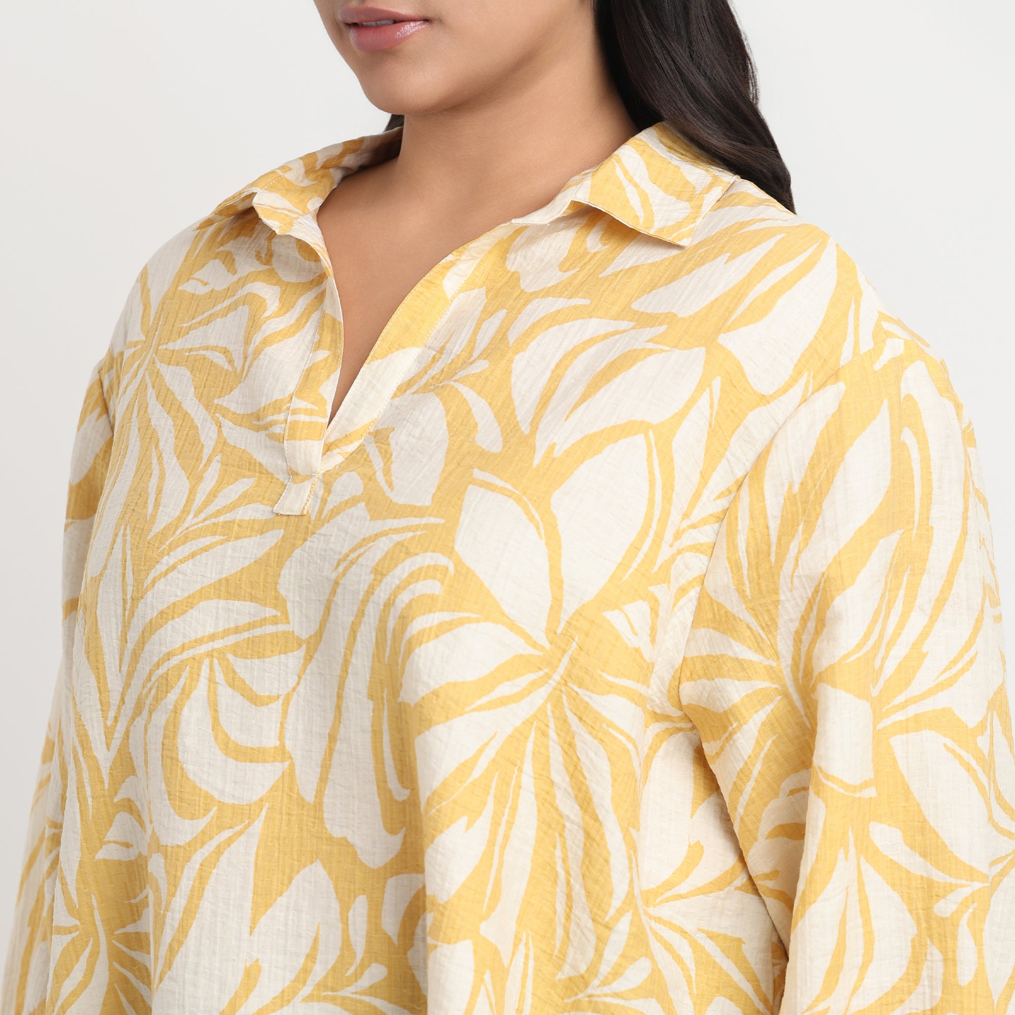 Yellow printed shirt with vibrant patterns, long sleeves, and a comfortable fit.
